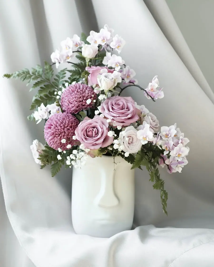A soft lavender and mauve floral arrangement in a sculptural vase