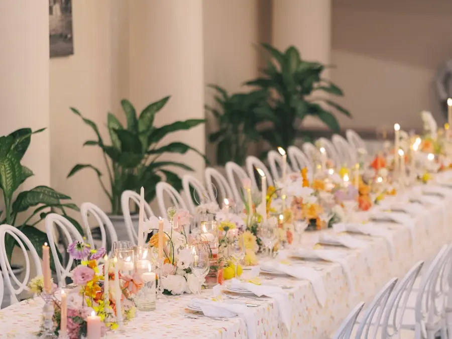 A long dining table styled with candles and pastel florals